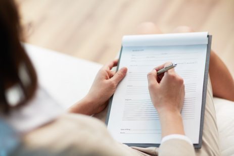 woman filling out paperwork at doctor