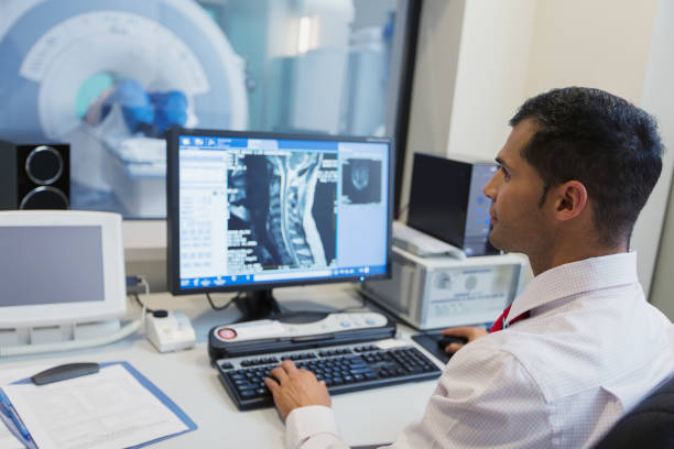 technologist conducting MRI scan