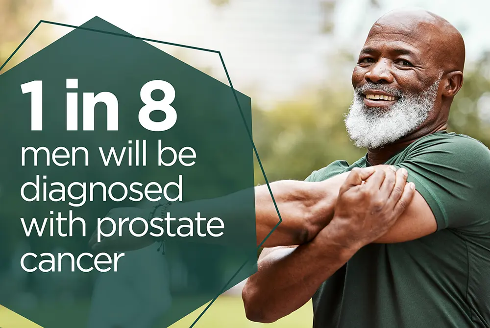A smiling man stretching on a banner with the text: 1 in 8 men will be diagnosed with prostate cancer.