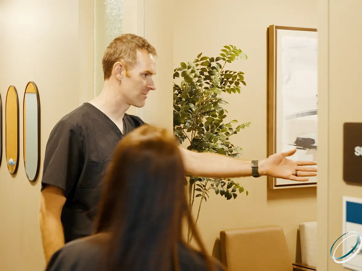 A patient is guided to the changing area after the exam.
