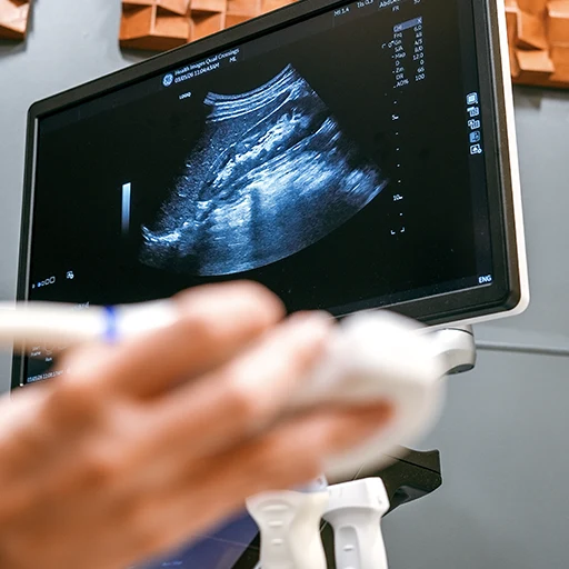 A Radiologist uses an Ultrasound machine.