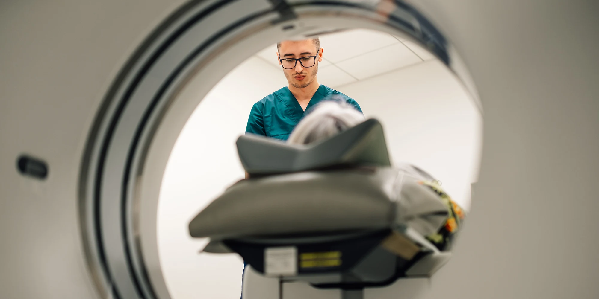 A tech helps a patient with a scan